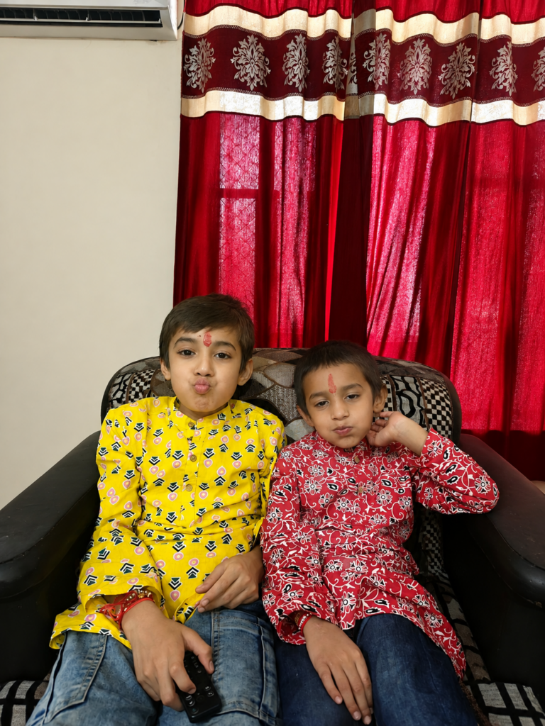 Vihaan and Mehaank sitting together in bright coordinated outfits